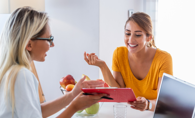woman happy client orange sweater working with her nutritionist