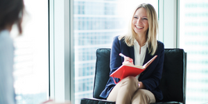 nutritionist interviewing a patient blonde woman smiling